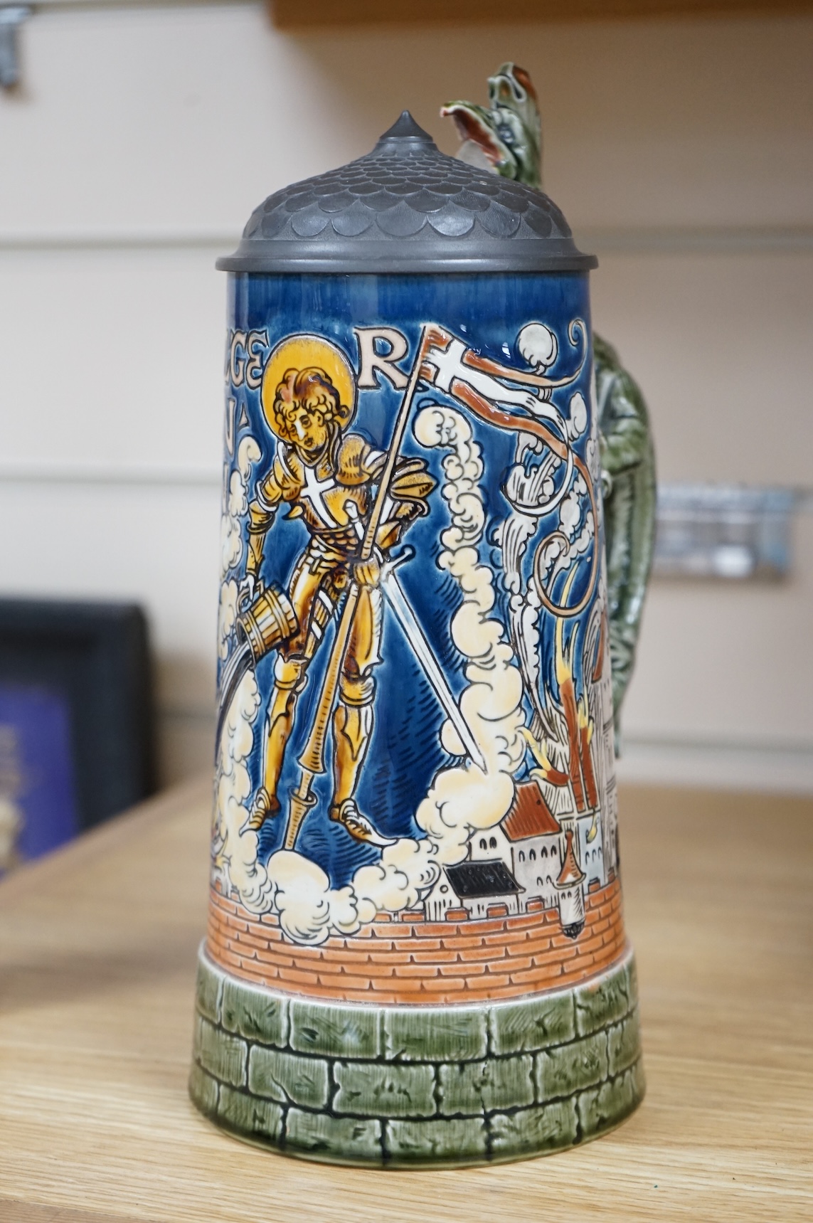 A Mettlach ‘ St Florian‘ stoneware stein, 27cm